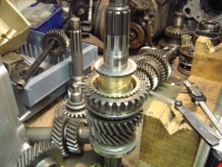  Third, second and reverse gears (and bushes and synchro rings) refitted to the mainshaft and checking endfloat in first gear bush here (large brass bit at top of shaft)